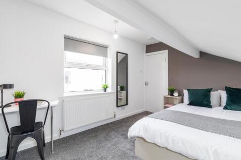 Bright, modern upstairs bedroom with a comforta...