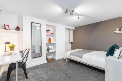 Bright, modern double bedroom with neutral deco...