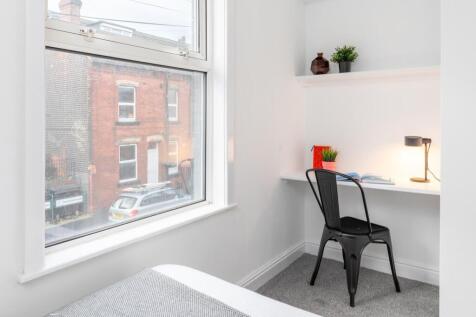 Bright, neatly presented bedroom with a comfort...