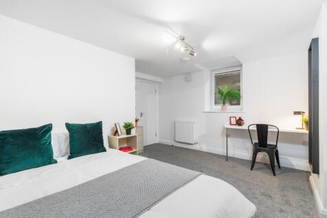 Bright, neatly presented bedroom with a comfort...