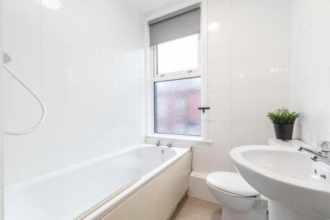 Bright, modern bathroom with a full bathtub, wh...