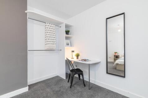 Bright, modern bedroom with neutral decor featu...