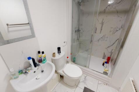 Bright and clean bathroom featuring a toilet, s...