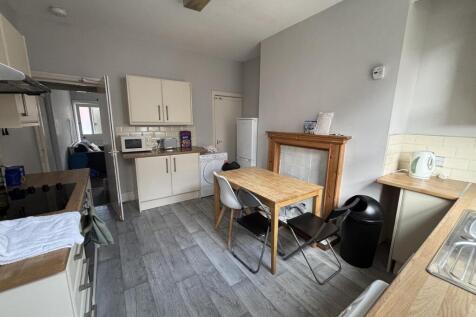 A well-lit, tidy kitchen space featuring modern...