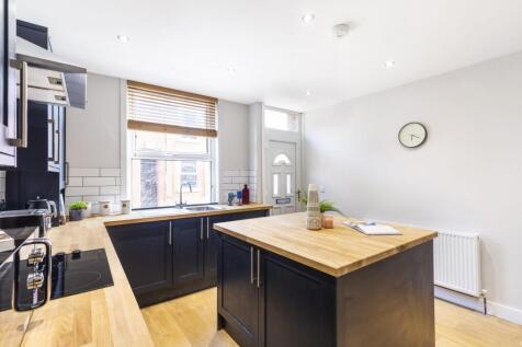 Bright modern kitchen with a central island, ti...