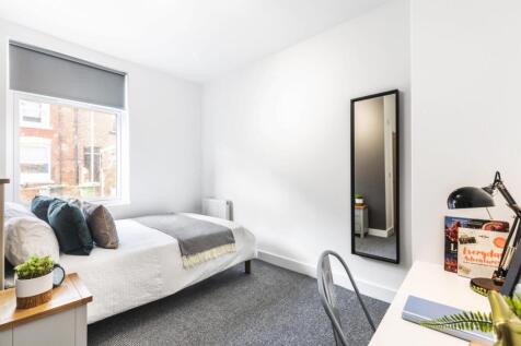 Bright, neatly presented bedroom with a comfort...