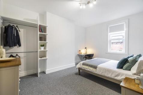 Bright, freshly painted bedroom with neutral ca...