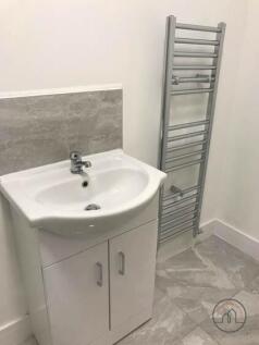 A clean bathroom with a modern sink unit and a ...