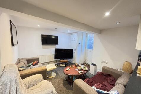 A spacious and modern living room featuring com...