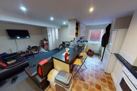 A spacious and well-lit living room featuring m...