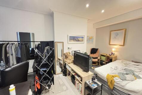 A spacious and modern living room with ample na...