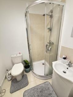 A well-maintained bathroom featuring a shower e...