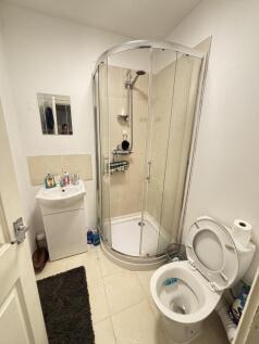 A modern bathroom featuring a shower enclosure,...