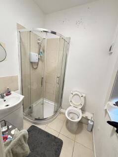 A modern bathroom with a shower cubicle, toilet...