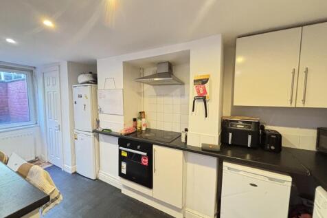 A modern, well-organized kitchen featuring whit...