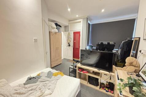 A cozy living room featuring a comfortable sofa...