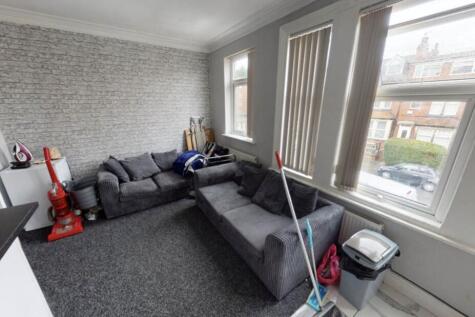 A spacious and well-lit contemporary living roo...