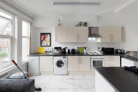 Modern kitchen with ample natural light, clean ...