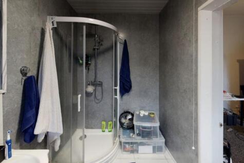 Bright and modern bathroom featuring a large sh...