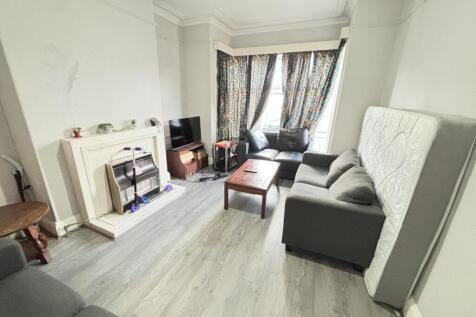 A bright and spacious living room featuring a l...