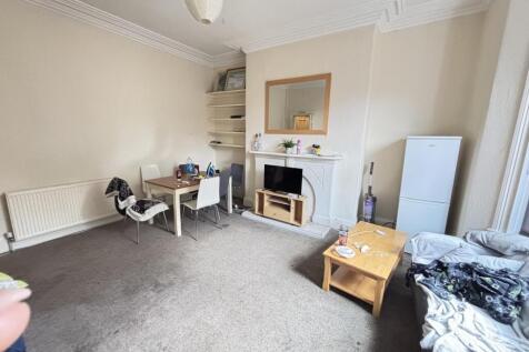 A spacious and well-lit contemporary living roo...