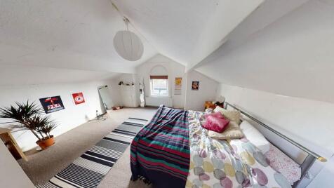 Bright and spacious master bedroom featuring a ...