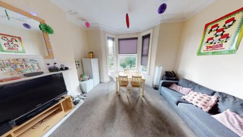 Bright and welcoming living room featuring larg...