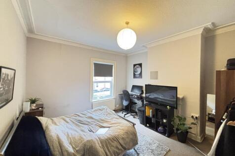 A bright and welcoming living room featuring a ...