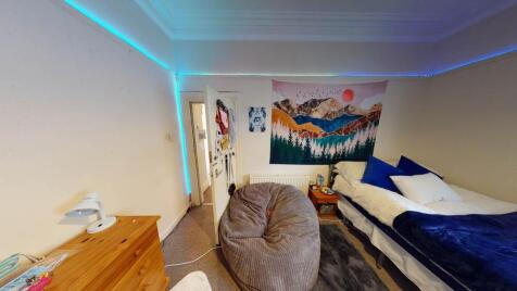 A bright and inviting double bedroom featuring ...