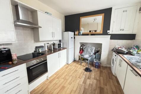 A bright, modern kitchen with ample storage and...