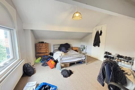A cozy bedroom with natural light coming throug...