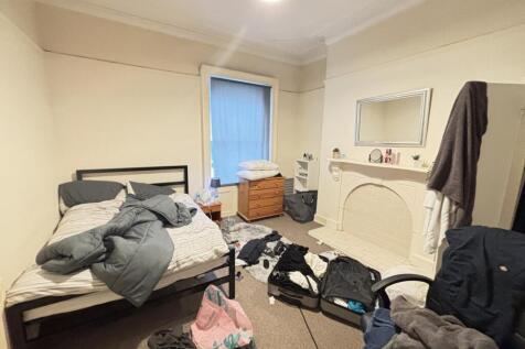 A well-used bedroom with a double bed and some ...