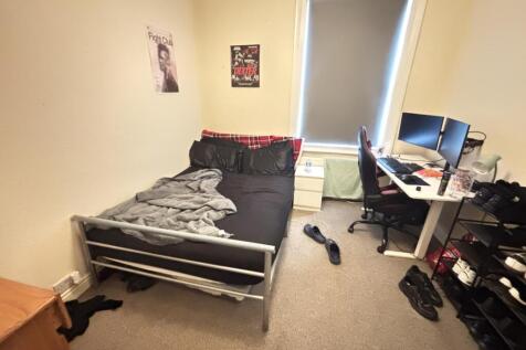 A compact and functional room with basic furnis...