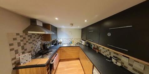 Modern kitchen with ample countertop space and ...