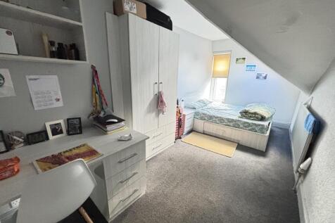 A bright and well-organized bedroom with a comf...