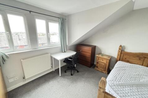 A cozy and well-maintained bedroom featuring a ...