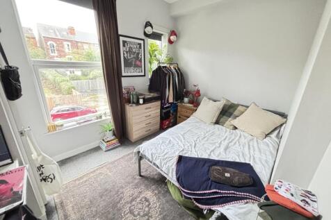 Bright and welcoming master bedroom featuring a...