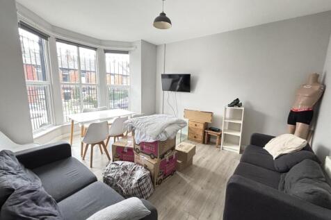 A bright and inviting living room with large wi...