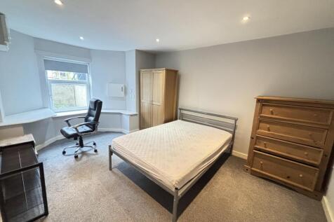 A well-maintained bedroom featuring a double be...