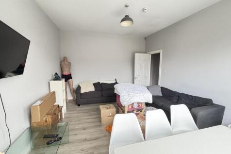 A spacious, well-lit living room with a contemp...