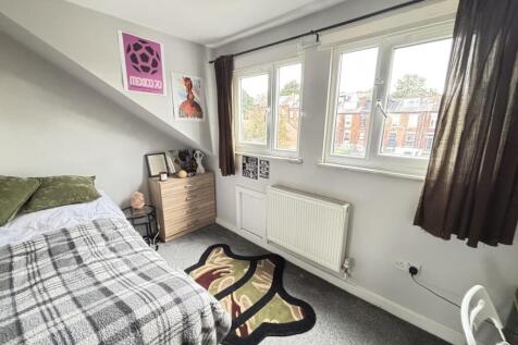 A bright and inviting bedroom with a comfortabl...