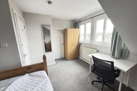 A bright and welcoming student bedroom featurin...