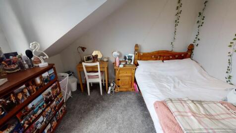 A bright and cozy double bedroom featuring a co...