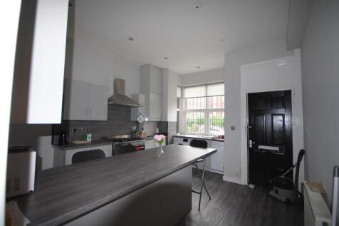 A modern, well-lit kitchen with large windows p...