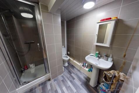 A clean and functional bathroom with a shower e...