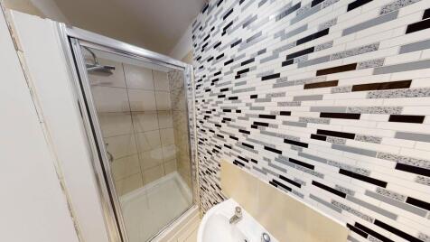 A clean and bright bathroom featuring a large s...