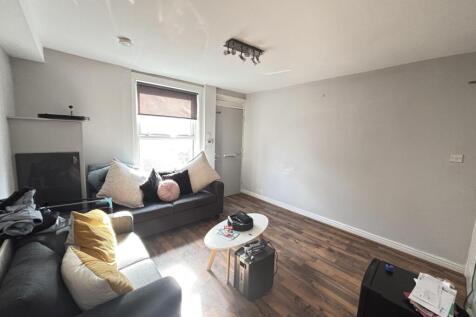 A bright and welcoming living room featuring a ...