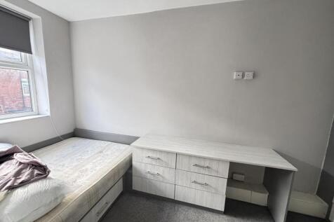 A bright, well-maintained bedroom featuring a s...