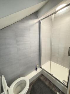 A modern and clean bathroom featuring a toilet ...