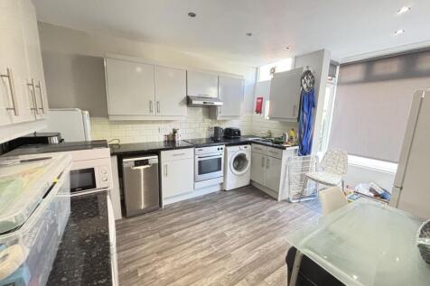 Bright and modern kitchen with ample cabinetry,...